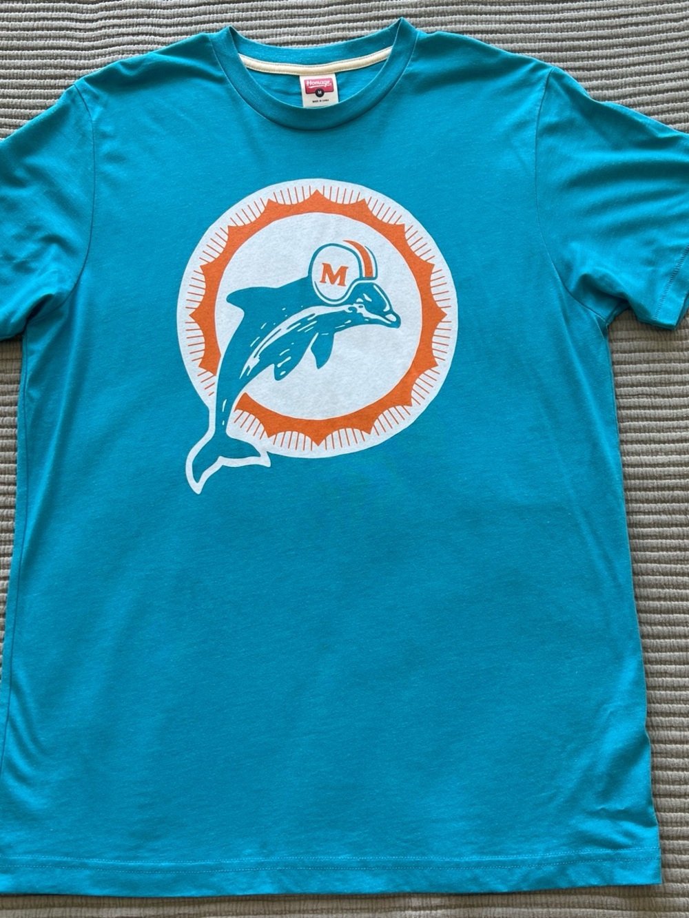 HOMAGE Teal Dolphin Graphic Short Sleeve Tee with Orange Accent